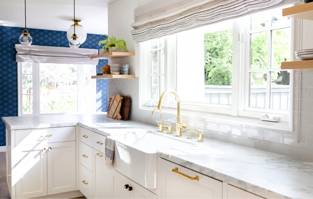 a white open kitchen with a painted blue wall